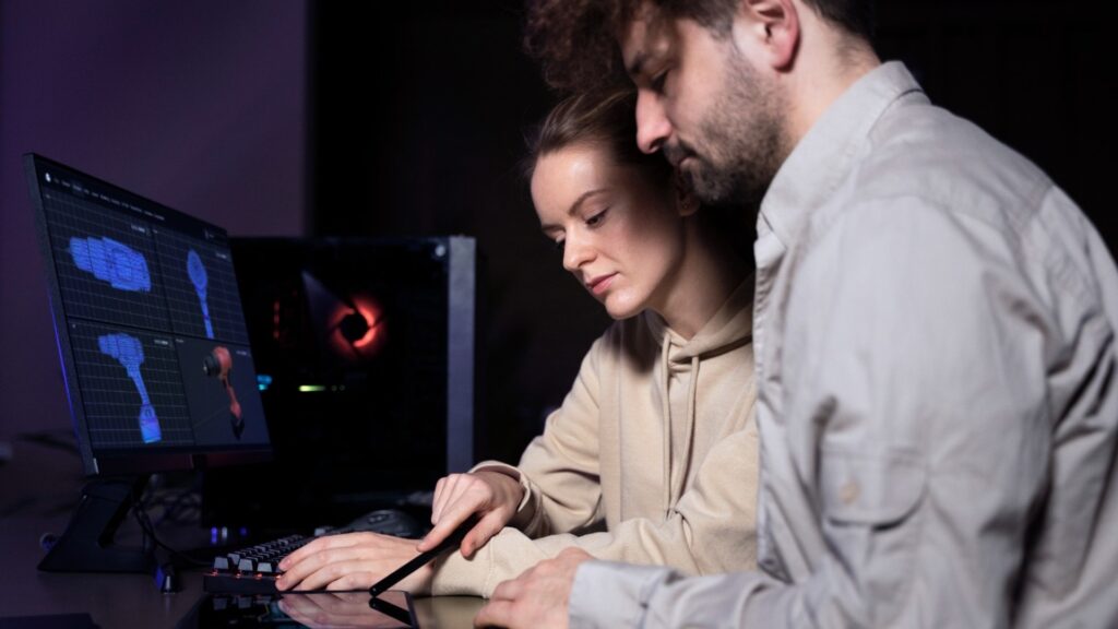 Estudiantes colaborando en el diseño de modelos 3D en un entorno educativo gamificado, utilizando plataformas tecnológicas para mejorar el aprendizaje práctico.